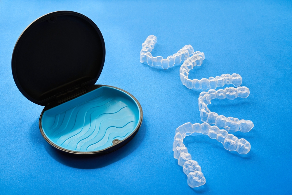 A small plastic case containing a toothbrush and a tube of toothpaste, designed for travel or personal hygiene.